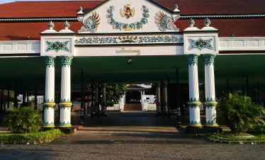 The entrance of the Yogyakarta Palace (Kraton Yogyakarta) featuring traditional Javanese architecture and guardian statues, a must-visit highlight on a Yogyakarta Day Trip.