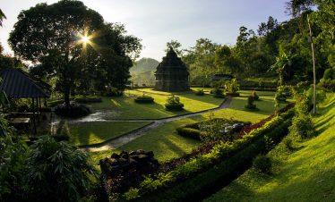 Beautiful morning view during Selogriyo trekking in Central Java, Indonesia, featuring lush green landscapes, ancient temple ruins, and serene natural surroundings illuminated by sunrise.