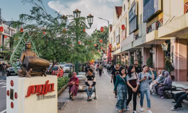 Vibrant atmosphere on a busy Jogja street filled with people exploring local shops and enjoying Jogja street food, showcasing the lively culture and charm of Yogyakarta, Indonesia.
