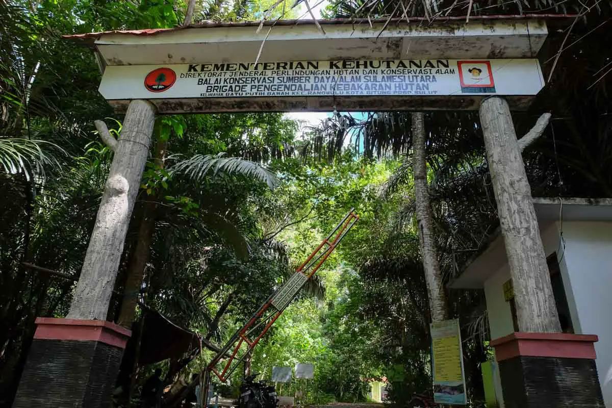 Entrance gate surrounded by tropical forest at Tangkoko National Park in North Sulawesi, Indonesia.
